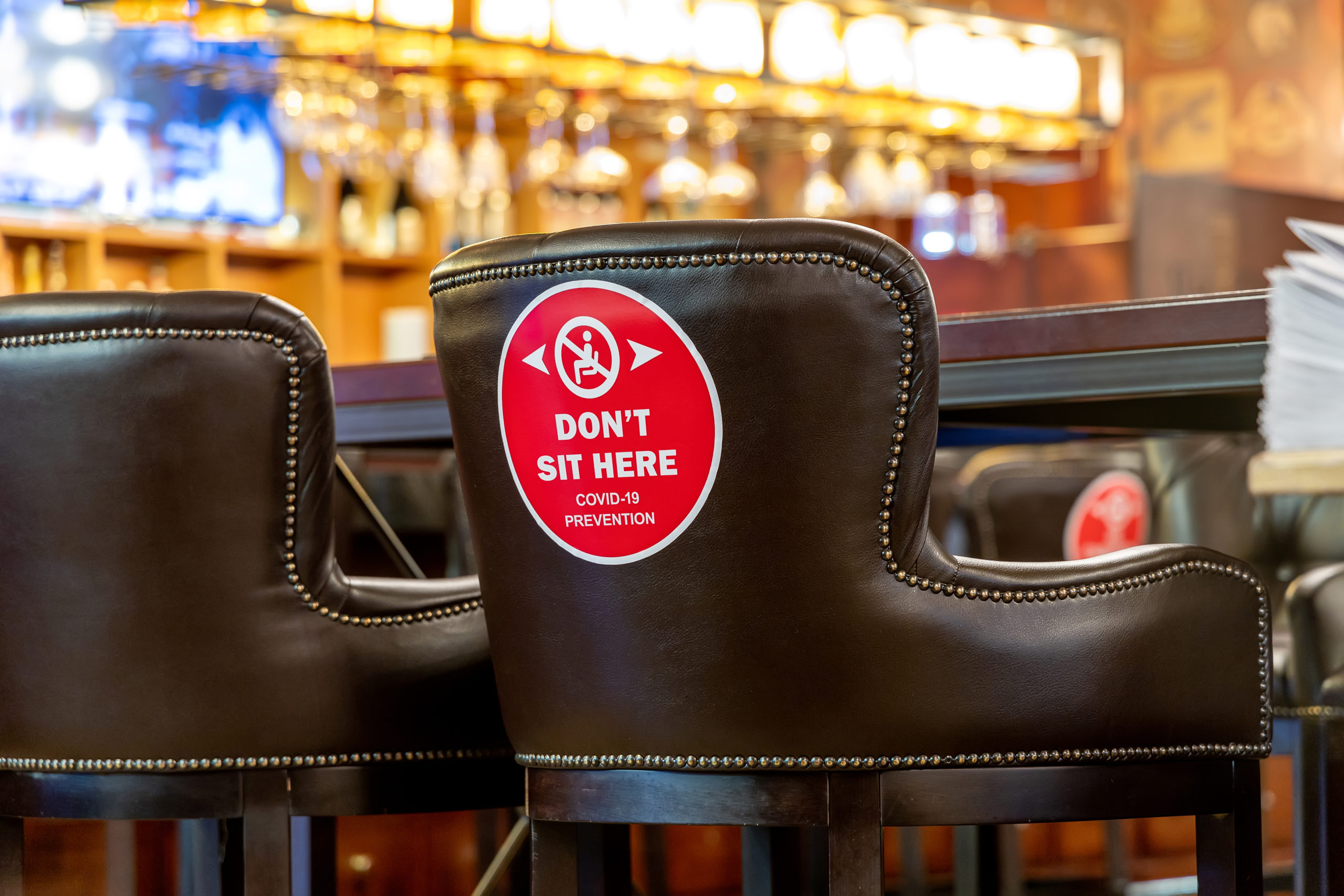 social distancing sign on a chair