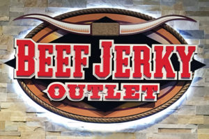 beef jerky outlet sign with bull horns in red brown white and black