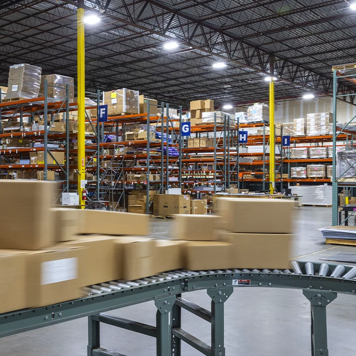 Boxes moving down a conveyor in a warehouse